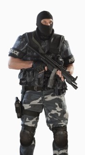 Police officer in gear holding assault rifle