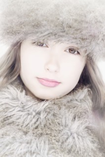 Close up of Caucasian girl wearing fur hat and scarf