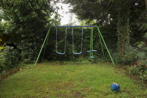 Empty swing set in backyard
