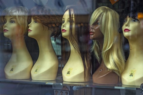 Mannequins and wigs in store window