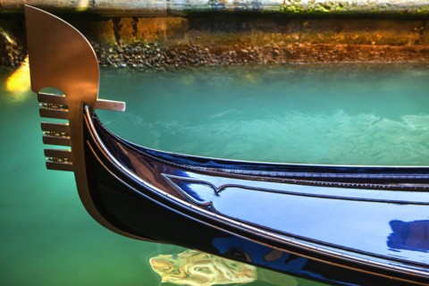 Close up of ornate gondola decoration on canal
