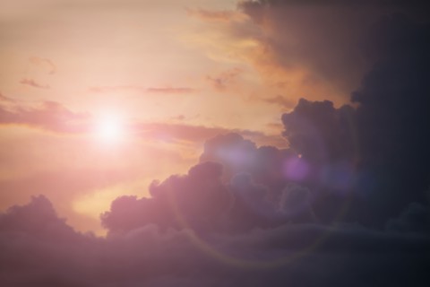 Sunbeams shining in cloudy sky