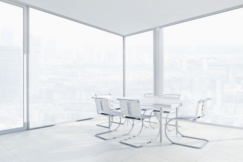 Empty chairs and conference table in office