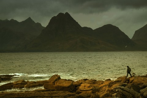 Man walking on rocky beach