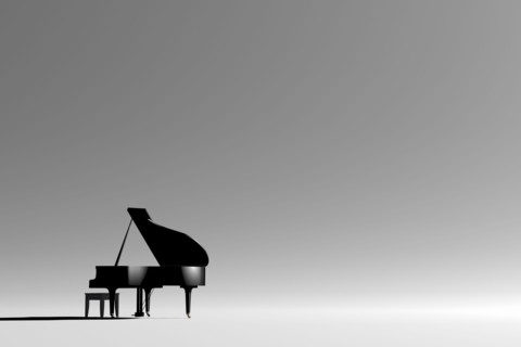 Grand piano and bench in empty room
