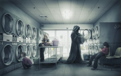 Grim Reaper doing laundry at laundromat