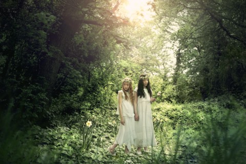 Caucasian girls exploring garden