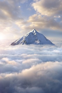 Snow-covered mountaintop above clouds