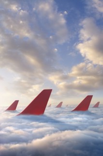Airplane rudders above clouds