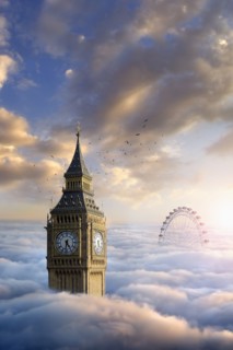 Birds flying around clock tower near ferris wheel above clouds
