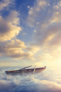 Empty rowboat above clouds