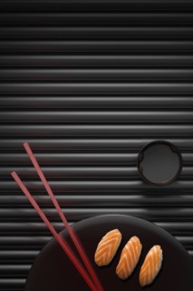 Chopsticks and sushi on round plate with dipping sauce