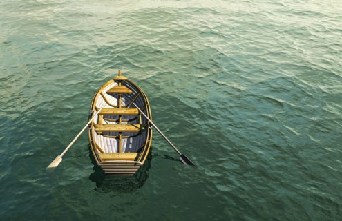 Abandoned rowboat in ocean