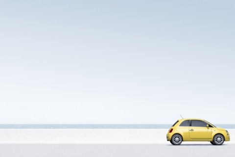 Yellow car near ocean