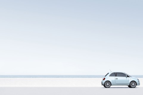 Blue car near ocean