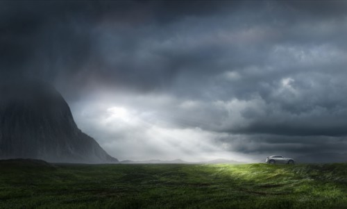 Silver sports car in lush green landscape