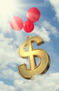 Red balloons lifting dollar symbol in cloudy sky