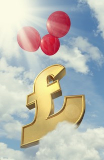 Red balloons lifting British pound symbol in cloudy sky