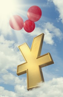 Red balloons lifting yuan symbol in cloudy sky