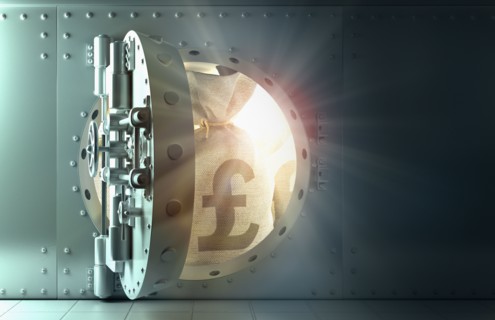 Back lit money bags with British pound symbol in vault