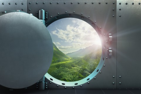 Open vault door revealing lush green sunny landscape