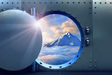 Open vault door revealing mountaintop above clouds