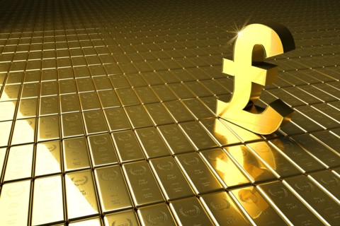 High angle view of gold bars and British pound symbol