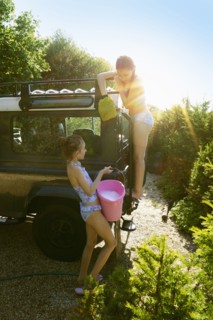 Caucasian girls washing truck