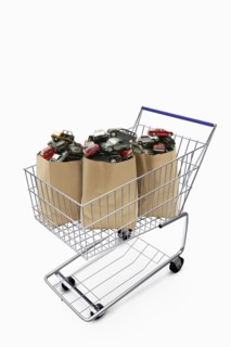 Paper bags in shopping cart filled with cars