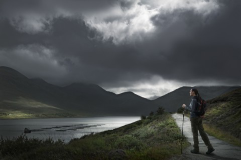 Caucasian woman hiking on path near river