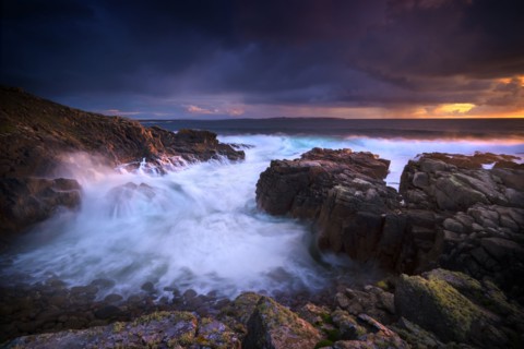 Waves flowing on rocky beach