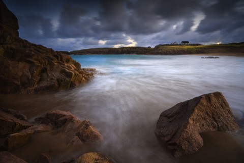 Calm waves on rocks at sunset