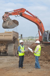 Hispanic construction workers talking on construction site