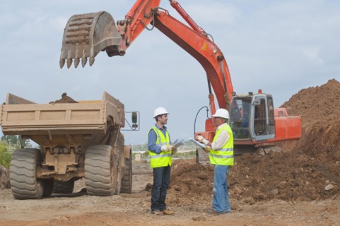 Hispanic construction workers talking on construction site