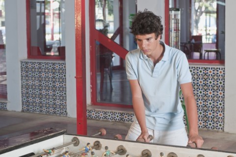 Hispanic teenager playing foosball