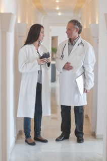 Hispanic doctors standing together in hospital corridor