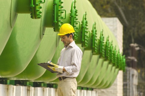 Hispanic worker checking tanks