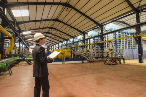 Hispanic businessman checking machinery