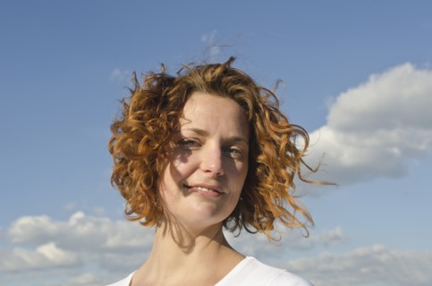 A young red-haired woman outdoors