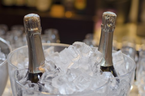 Wine bottles in ice bucket in restaurant