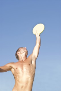 young man catching frisbee