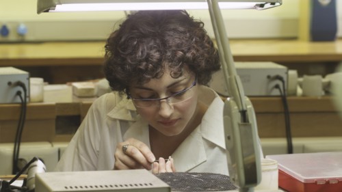 Female jeweller working on piece of jewellery