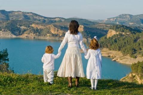 Spain Malaga mother and children looking at lake rear view