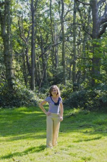woman standing in clearing in forest