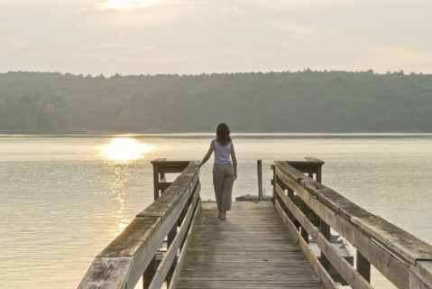 woman looking out to sea from jetty