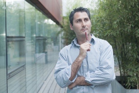 young man looking pensively into distance