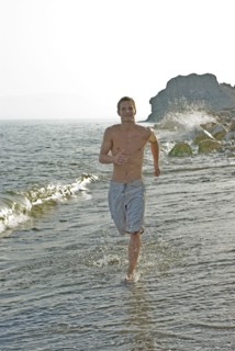 young man running in surf