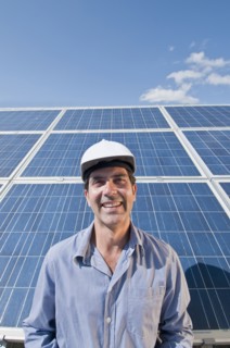 engineer in front of solar panels