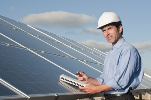 engineer with plans and solar panels