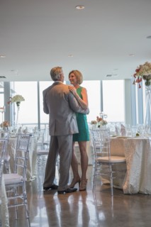 Caucasian couple dancing in empty restaurant
